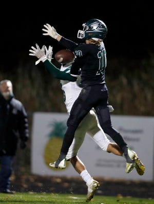 Williamston's Max McCune, right, breaks up a pass intended for Olivet's Ramsey Bousseau, Friday, Oct. 14, 2022, in Williamston. Williamston won 29-22.