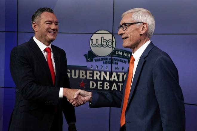 Wisconsin Republican gubernatorial candidate Tim Michels, left, and Democratic Gov. Tony Evers shake hands before a televised debate, Friday, Oct. 14, 2022, in Madison.