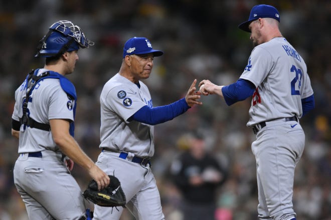 Los Angeles Dodgers manager Dave Roberts takes the ball from pitcher Andrew Heaney in the fifth inning against the San Diego Padres.