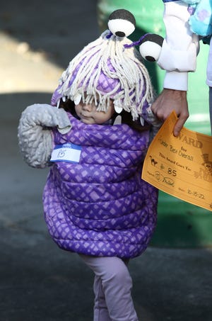 Cadence Mayle, 2, dressed as Boo from "Monsters. Inc." and won best overall costume in her category Saturday, Oct. 15, 2022, during the Alliance City Parks' Fall Festival held at Silver Park.
