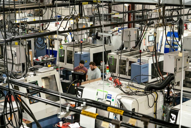 Andrew VanRynen, left, and Jeff Thurman check a tool at IMCO Carbide Tool in Perrysburg, Ohio, on Oct. 7.