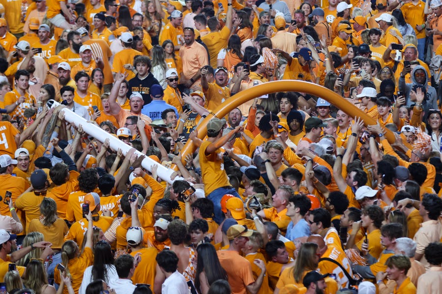 Tennessee Volunteers fans carry the goal posts after defeating the Alabama Crimson Tide at Neyland Stadium.