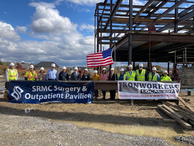 Salem Regional Medical Center recently conducted a beam-raising event for its new surgery and outpatient pavilion. Pictured with the final beam are members of SRMC’s Board of Directors and administration, and representatives from Shook Construction and Wilmont Sanz.