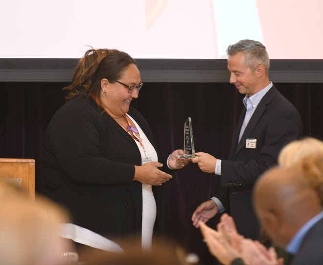 Union YWCA Executive Director Stacie Weimer accepts the Small Business of the Year Award at the Union Area Chamber of Commerce Business Union Awards Luncheon at the Hoover Price Campus Center in Mount Union.  Monday, October 17, 2022.