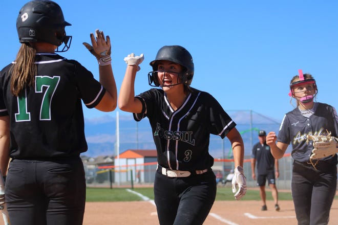 Fossil Ridge softball player Anna Javernick (3) celebrates with teammate Katelyn Hays (17) after scoring a run against Arapahoe during a Class 5A regional softball game at Erie on Friday, Oct. 14, 2022.