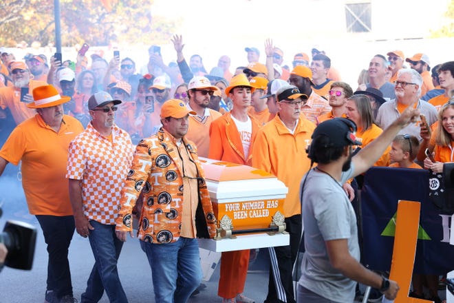 Six "Paul-bearers" carry a Tennessee casket housing Paul Finebaum of "SEC Nation" during a Saturday, Oct. 15, 2022, airing in Knoxville, Tennessee. Horace Perkins III is the "Paul-bearer" at the front right. Behind him are Horace Perkins IV and Neyland Perkins. Jeffrey Dillard is at front left. Behind him are Michael Moore and Chris Holland.