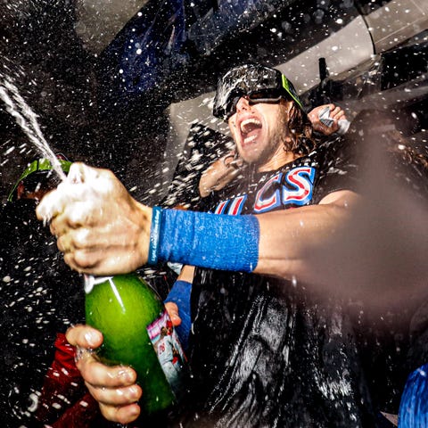 Phillies third baseman Alec Bohm sprays champagne 
