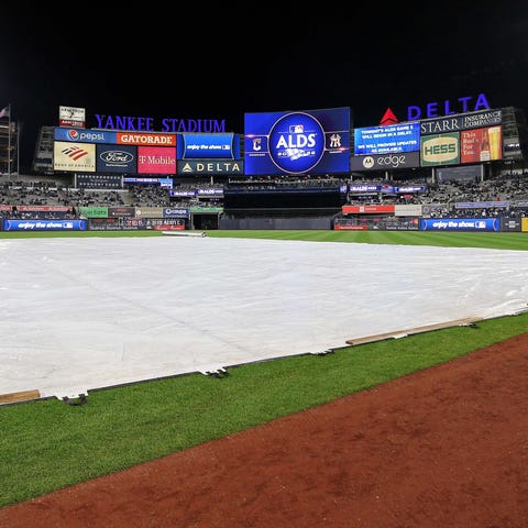 The tarp is on the field as the video board indica