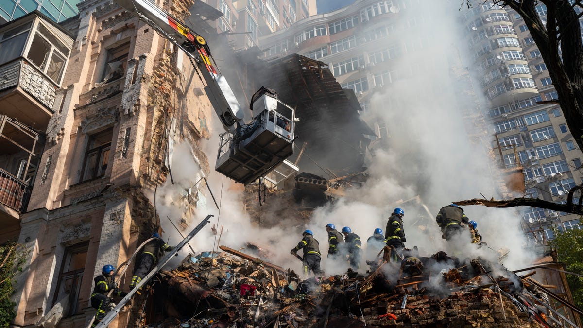 October 17, 2022:  Firefighters work after a drone attack on buildings in Kyiv, Ukraine. Waves of explosive-laden drones struck Ukraine's capital as families were preparing to start their week early Monday, the blasts echoing across Kyiv, setting buildings ablaze and sending people scurrying to shelters.