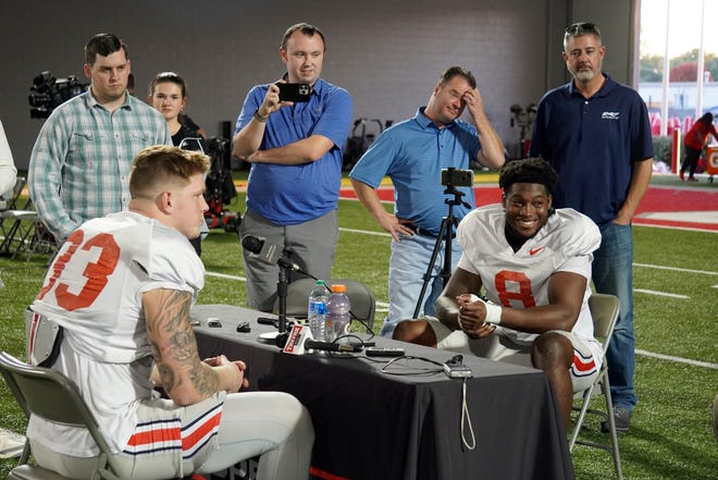 Ohio State defensive end Javontae Jean-Baptiste (8) sits with reporters at a press availability for teammate Jack Sawyer.