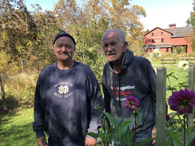 Steve Kuiper, left, and Mac Boyer enjoy a sunny day at Bonneyville Mill in Bristol. Both men belong to the Elkhart County Dahlia Society.