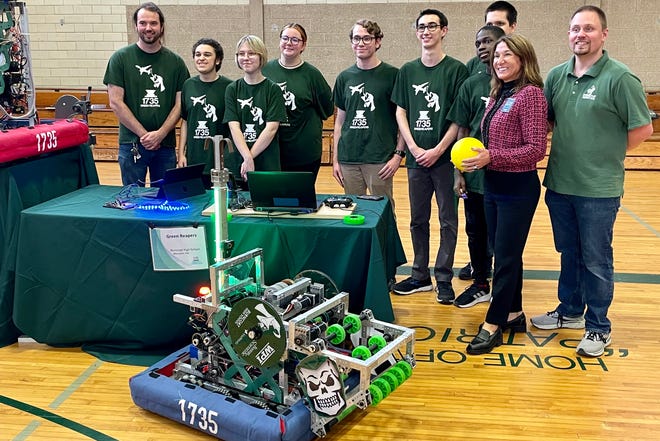 From right, Burncoat robotics coach Nicholas Galotti and Lt. Gov. Karyn Polito, with the Burncoat Green Reapers robotics team and their robot.