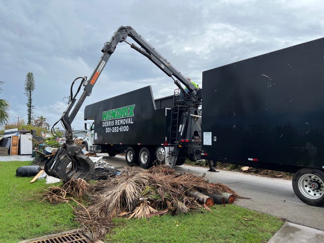 Contractor Hendricks picks up debris in his southeastern Cape Coral neighborhood to pick up storm debris.