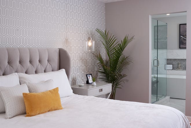 Contemporary and chic: This bedroom features an upholstered headboard with shelter sides and button tufts.