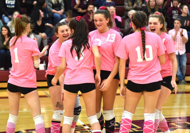 The Union City Chargers celebrate a big point late versus Quincy on Tuesday during Dig Pink Night