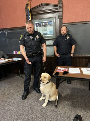 Kent police officer Dominic Poe, along with Police Chief Nicholas Shearer, introduces Matous, the department's newest K-9, to the Kent Board of Education. Matous works with Poe, a school resource officer, and serves as a therapy dog and firearms detection dog.