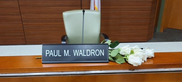 Flowers were left at the desk of St. Johns County Commissioner Paul Waldron on Tuesday.