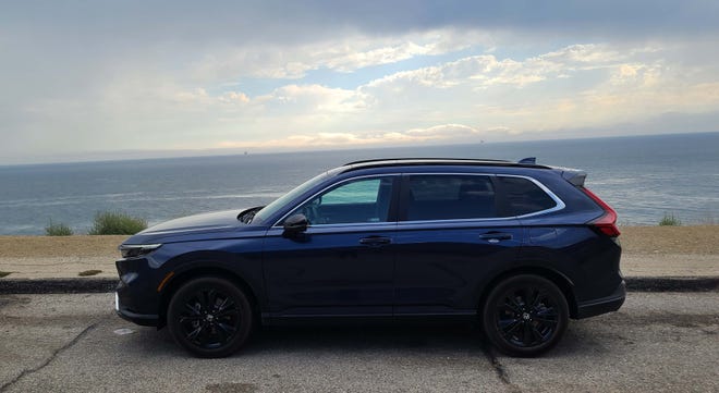 The brooding, dark Sport design style of the 2023 Honda CR-V Hybrid meets the brooding Pacific Ocean.