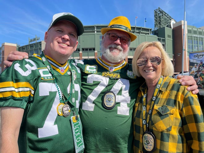 Scott Schwartz, center, is one of the captains of the Lot 1 tailgating group known for its popular party outside Lambeau Field. Schwartz and his wife Lisa are featured on the newest episode of "Emeril Tailgates."