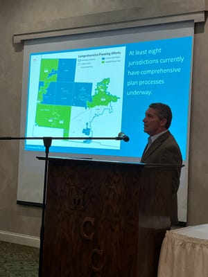 Jamie Greene, with Planning NEXT, stands in front of a map showing the different Licking County jurisdictions participating in the Framework planning effort ahead of Intel. The slide was part of a presentation made during a Licking County Chamber of Commerce breakfast on Wednesday, Oct. 19, 2022.