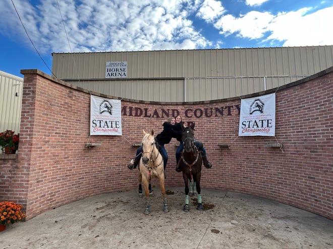 Port Huron High School Equestrian Team members Brylynn Balon (left) and Madison Camm pose at the Michigan Interscholastic Horsemanship Association State Championships at the Midland County Fairgrounds in October 2022.