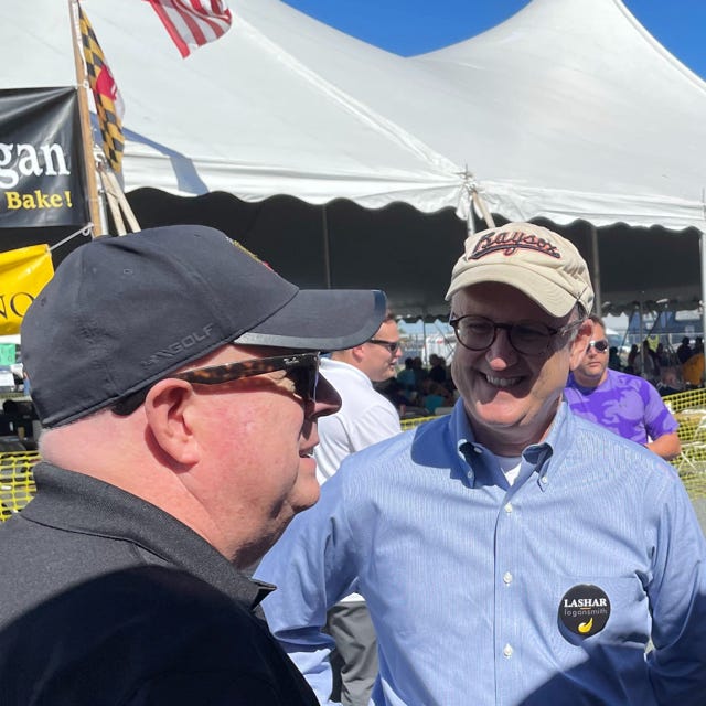Libertarian Party gubernatorial candidate David Lashar, talks with outgoing Republican Gov. Larry Hogan during a Crisfield election event. He said his campaign is to push the Republican Party more towards the center.