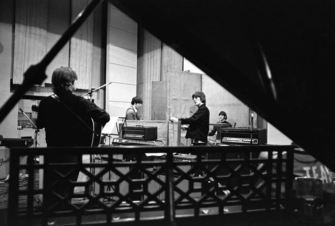 John Lennon, Paul McCartney, George Harrison and Ringo Starr are working on "Revolver" at Abbey Road Studios.