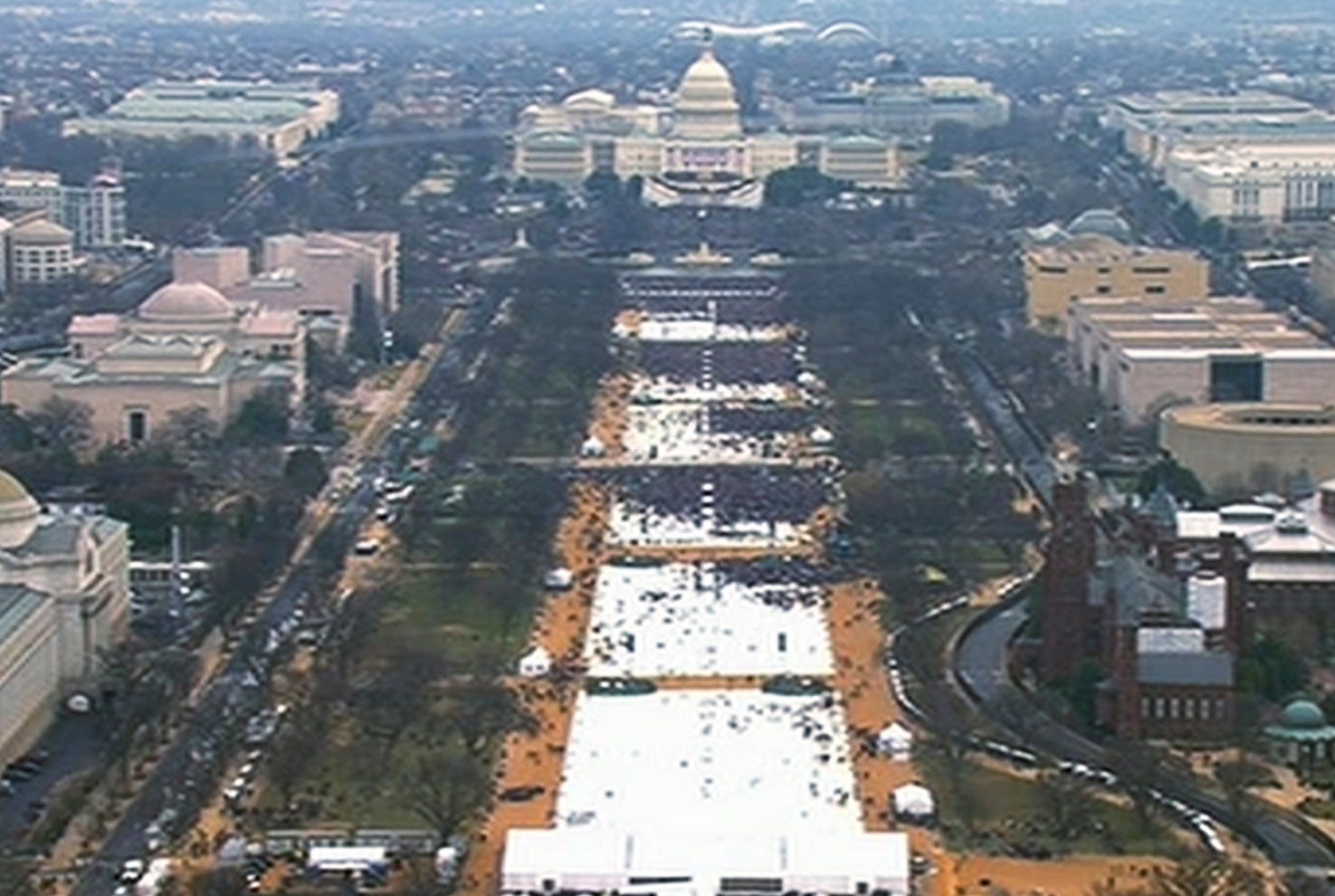 FILE- This pair of photos shows a view of the crowd on the National Mall at the inaugurations of President Barack Obama, above, on Jan. 20, 2009, and President Donald Trump, below, on Jan. 20, 2017. The photo above and the screengrab from video below were both shot shortly before noon from the top of the Washington Monument. On his first full day in office, President Donald Trump called the acting director of the National Park Service to dispute widely circulated photos of Trump's inauguration. (AP Photo, File)