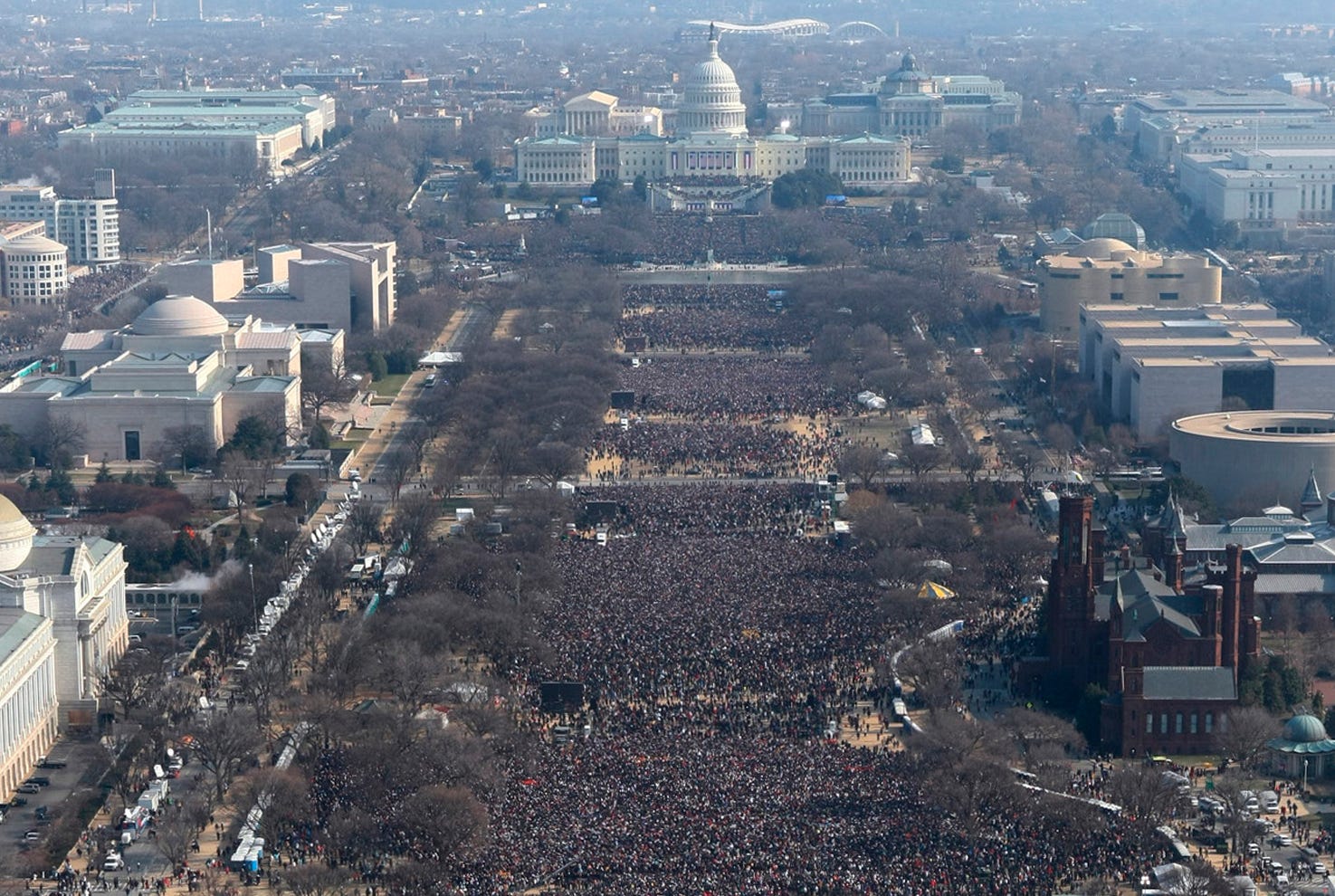 FILE- This pair of photos shows a view of the crowd on the National Mall at the inaugurations of President Barack Obama, above, on Jan. 20, 2009, and President Donald Trump, below, on Jan. 20, 2017. The photo above and the screengrab from video below were both shot shortly before noon from the top of the Washington Monument. On his first full day in office, President Donald Trump called the acting director of the National Park Service to dispute widely circulated photos of Trump's inauguration. (AP Photo, File)