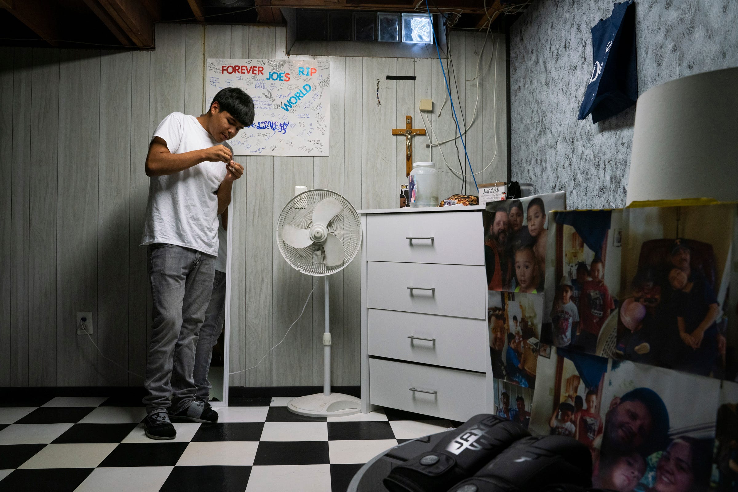 Justin Nankervis, 16, looks at a rosary while standing inside his room at his sister's home on Wednesday, Oct. 5, 2022. "That was my right-hand man. That was my baby brother," said Nankervis, whose younger brother, Joe Nankervis, 14, was shot and killed in southwest Detroit. "We were always together. We did everything together."
(Photo: Sarahbeth Maney, Detroit Free Press)