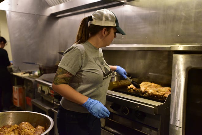 Doña Marina's owner Heather Fagan cooks grilled chicken during the new carryout restaurant's soft opening on Thursday, Oct. 20, 2022, at the Atrium Kitchen in Port Huron.