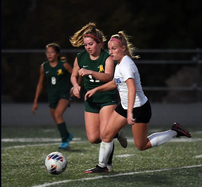 Bishop Manogue's Jaquelyn Buenting and McQueen's Ella Barber chase the ball during Tuesday's game at Bishop Manogue on Oct. 18, 2022. The game ended in a tie.