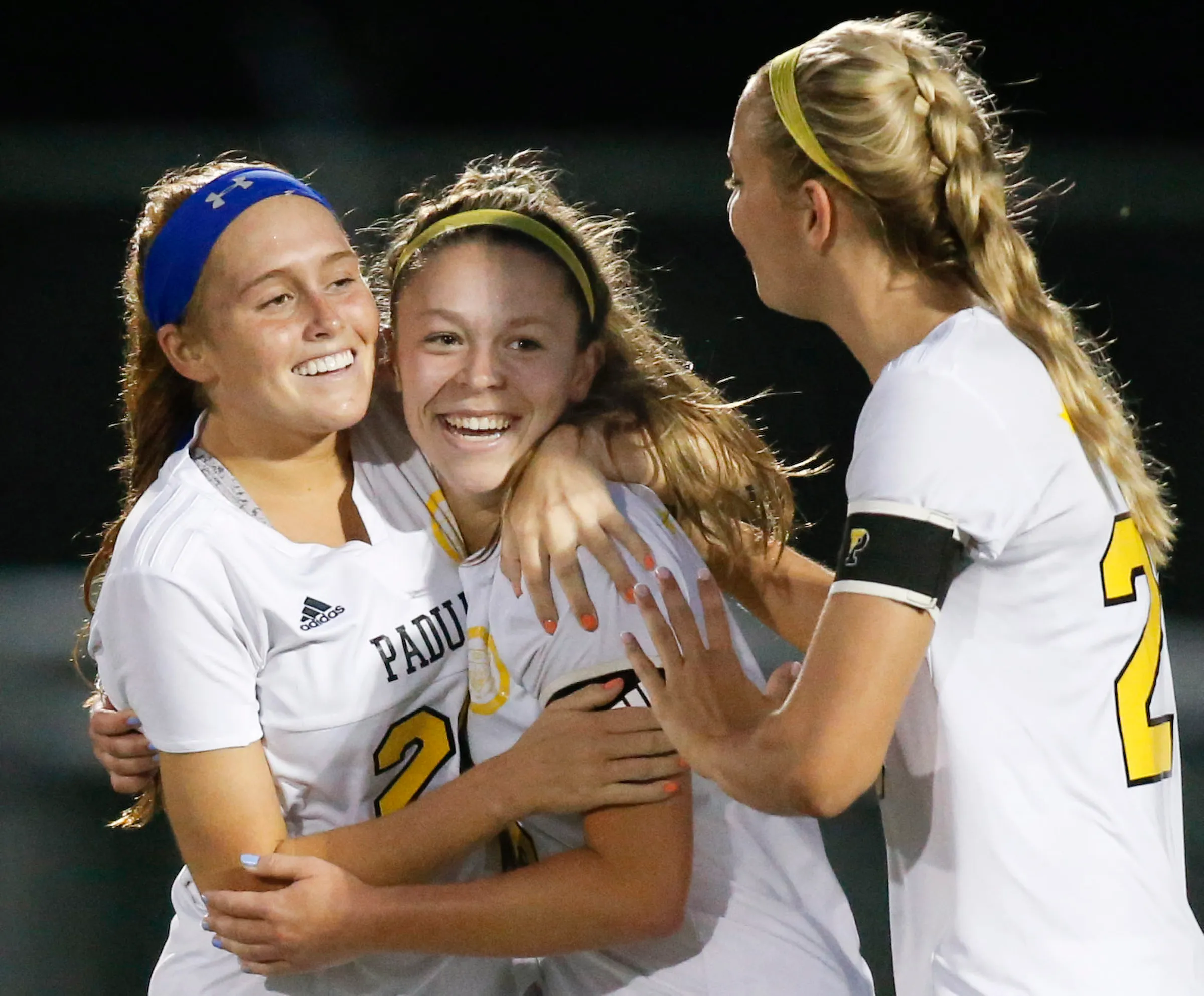 Padua's Sarah Brush (center) celebrates her opening goal with Mackenzie Scully (left) and Molly Drach in the first half against Caesar Rodney in the DIAA Division I state title game at Smyrna High School Friday.