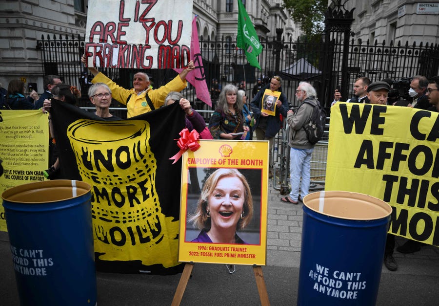 Protester gather outside the gates of Downing Street during a demonstration by the climate change protest group Extinction Rebellion, in central London on October 14, 2022. Truss has said that Greenpeace and Extinction Rebellion were part of an "anti-growth coalition" with trade unions and the main opposition Labour party determined to derail her economic reforms.