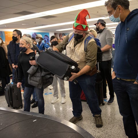 Michael Clancey wears an elf hat as he waits for h