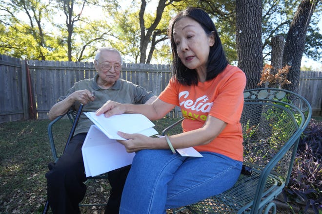 Alice Yi and her 92-year-old father Yilu Zhao discuss how his mail in ballot was rejected several times because of a non-ID match in Alice’s backyard Friday, Oct. 21, 2022, in Austin. Zhao’s application was accepted too late for him to vote by mail for primary elections but was able to vote by mail for this election.