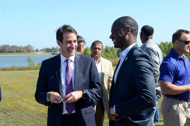 U.S. Congressman Garret Graves shares a laugh with state Rep. Ken Brass along the Mississippi River levee top in Donaldsonville during the Bayou Lafourche pump station groundbreaking held Oct. 21.