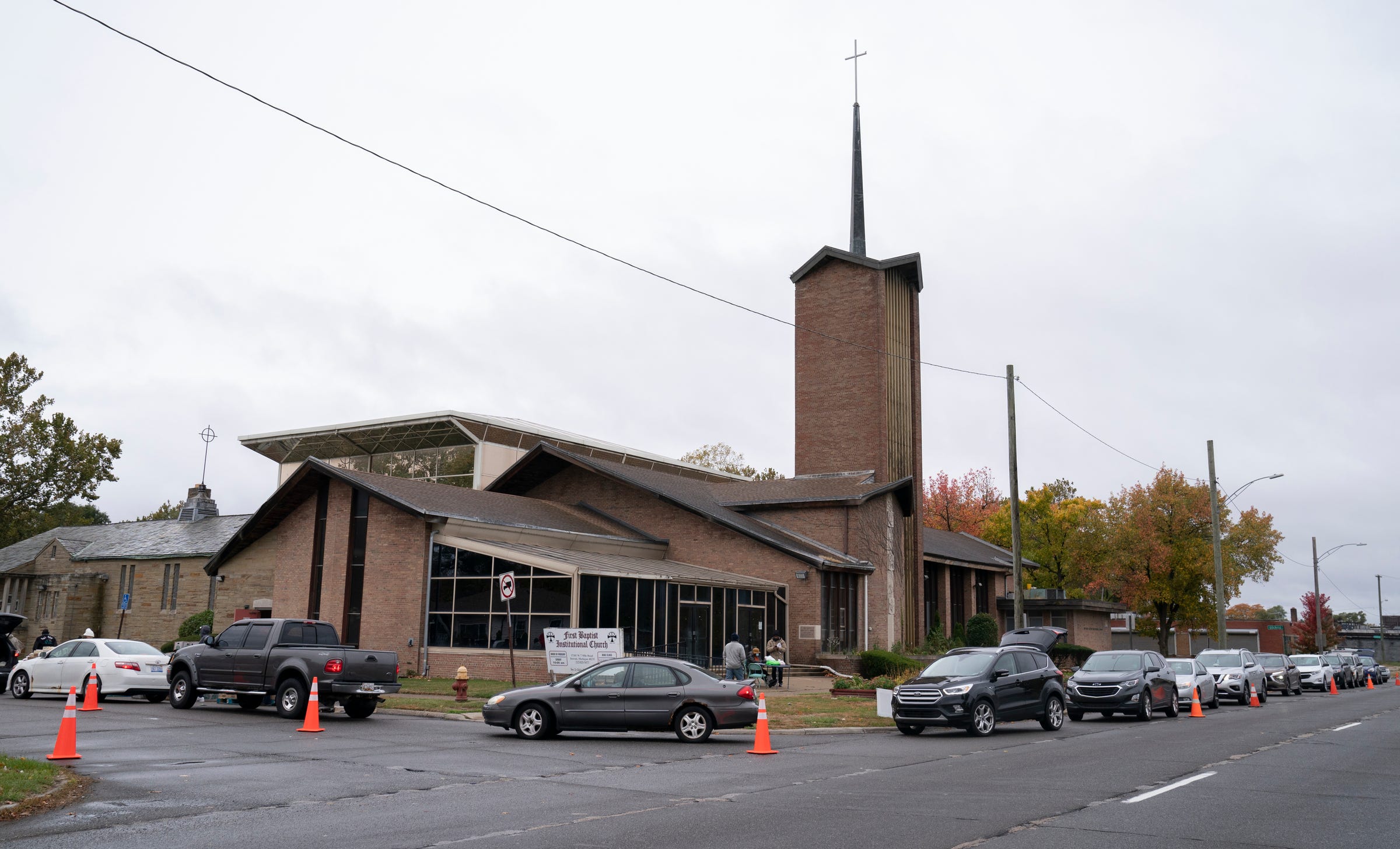 Cars gather around the building at First Baptist Church in Detroit Wednesday, October 19, 2022 during the first day established by Reverend Dr. Robin De Moore, the first woman to lead the First Baptist Church. Senior Day allows seniors to receive free food items from the church twice a month in partnership with Forgotten Harvest.