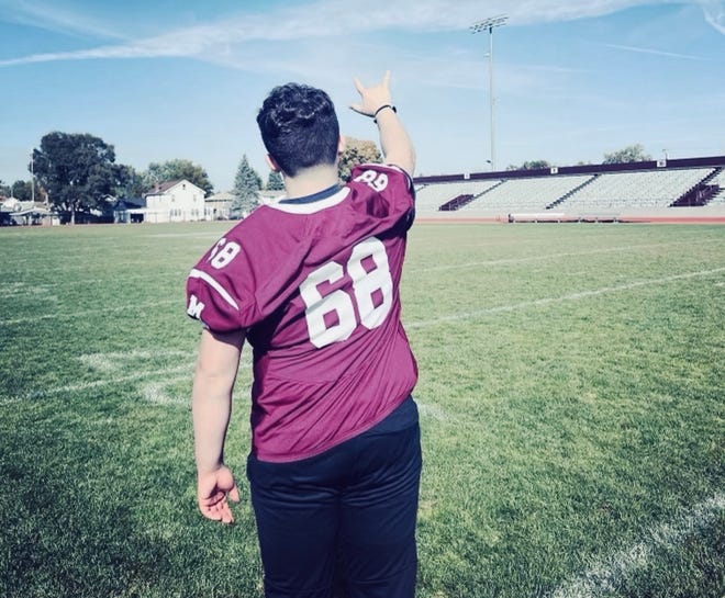 Jacob Bush, a senior guard at Mishawaka High, points to the sky, to his dad in heaven. Jacob's story is one of courage and perseverance after almost dying in a motorcycle crash that killed his dad.