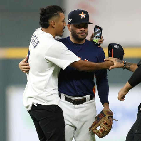 Astros second baseman Jose Altuve is approached by