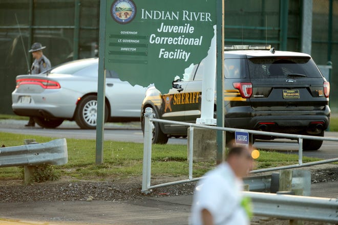 Ohio State Highway Patrol troopers and Stark County sheriff's deputies wait outside the Indian River Juvenile Correctional Facility in Massillon after incarcerated juveniles barricaded themselves inside on Saturday, Oct. 22, 2022.