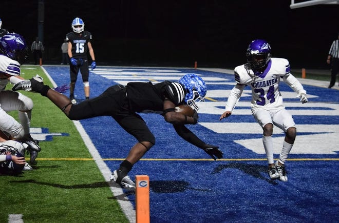 Omari Carter scores a touchdown for Gibraltar Carlson during a 38-18 victory over Woodhaven that clinched a share of the Downriver League championship for the Marauders.