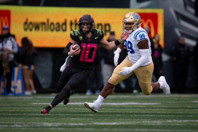 Oregon quarterback Bo Nix carries the ball as the Oregon Ducks take on the UCLA Bruins Saturday, Oct. 22, 2022, at Autzen Stadium in Eugene, Ore.