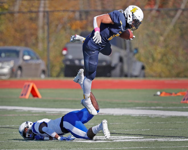 Siena Heights' Kaleb Jefferson leaps a defender during Saturday's game against Lawrence Tech.