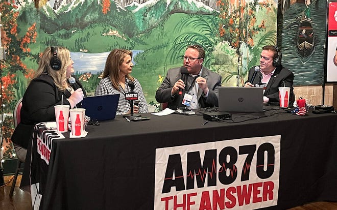 Lance Christensen, center, answers questions from Los Angeles radio AM 870 hosts Jennifer Horn and Larry Marino during a live broadcast in a Fullerton restaurant in early October.