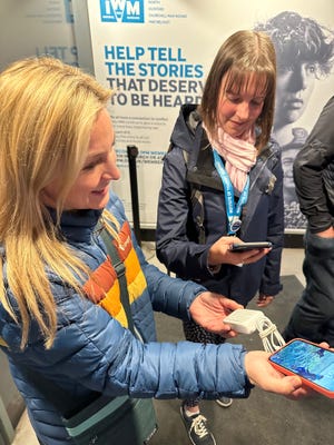 Jenn shows Blue Badge Tour Guide Amber Talon the Zendure portable battery charger.