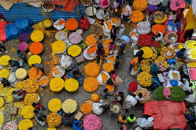 October 23, 2022: People crowd at a flower market on the eve of Diwali, the Hindu festival of lights, in Bangalore, India.
