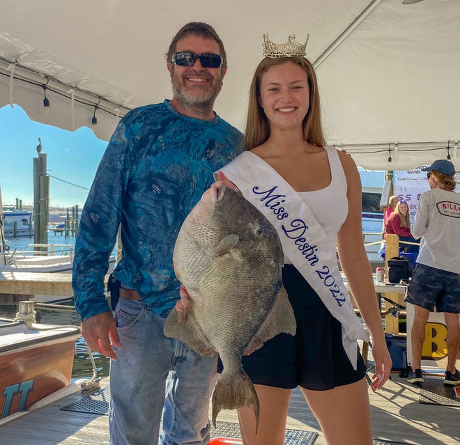 Kevin Chambers of Florala, Alabama landed this 9.4-pound triggerfish on Sunday to take a first place spot on the leaderboard of the Destin Fishing Rodeo. Also pictured is Miss Destin Ella Kathryn Campbell. He was fishing aboard the Windwalker II with Capt. Bernie LeFebvre.