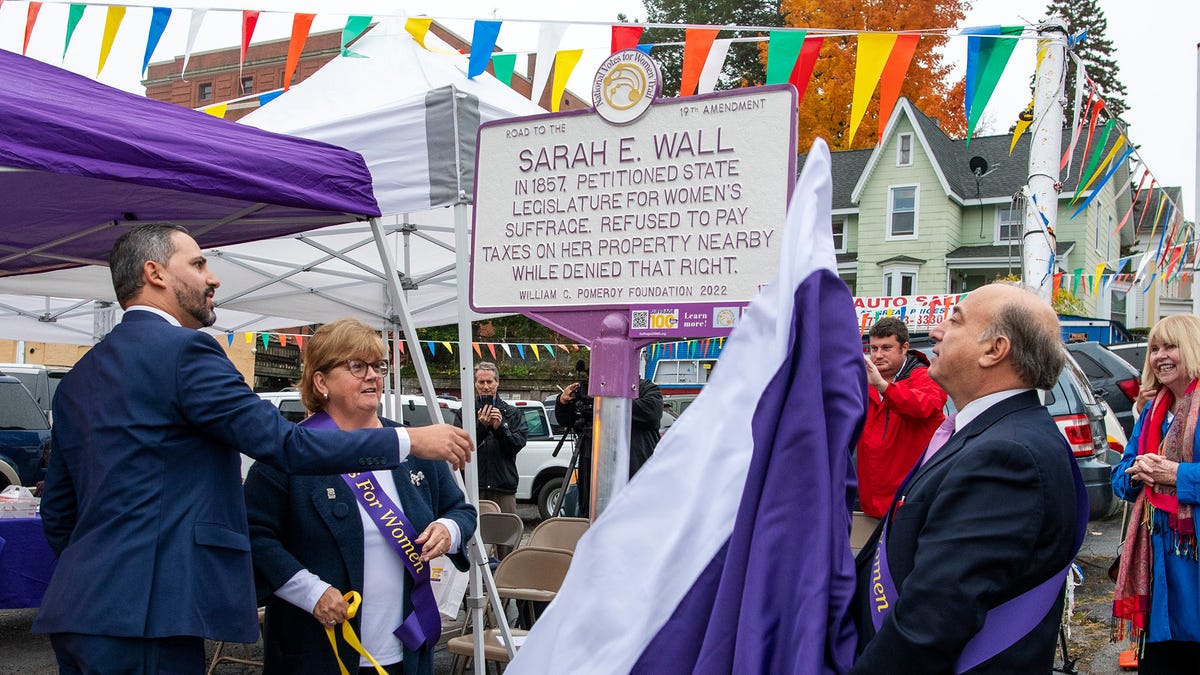 WORCESTER - A plaque dedicated to women's rights activist Sarah E. Wall is unveiled by Acting City Manager Eric D. Batista, Ward 2 City Councilor Candy Mero-Carlson, and City Councilor-At-Large Morris Bergman, left to right, on Main St. Monday, October 24, 2022.