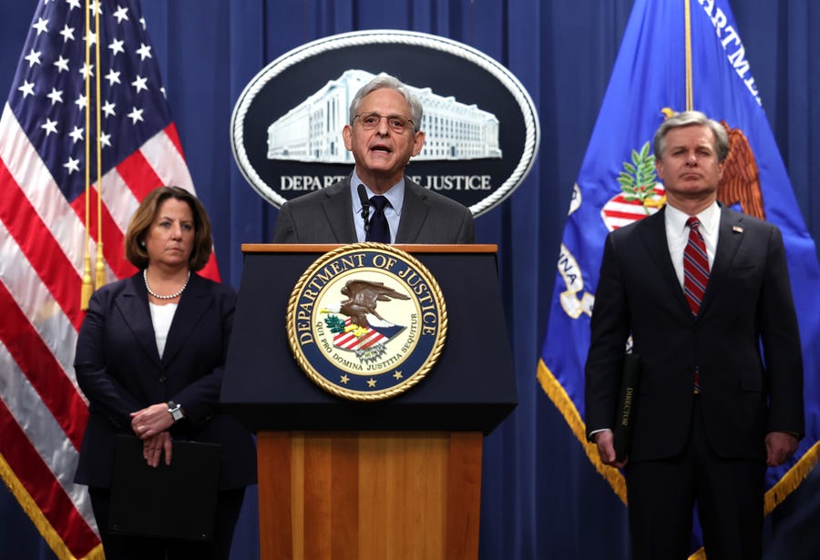 Attorney General Merrick Garland, F.B.I. Director Christopher Wray and Deputy Attorney General Lisa Monaco hold a press conference at the U.S. Department of Justice on Monday in Washington, DC. The Justice Department announced it has charged 13 individuals, including members of the Chinese intelligence and their agents, for alleged efforts to unlawfully exert influence in the United States for the benefit of the government of China.